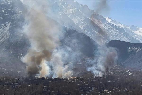 Thick plumes of smoke billow over Skardu as protesters set ablaze government and private properties during violent demonstrations.